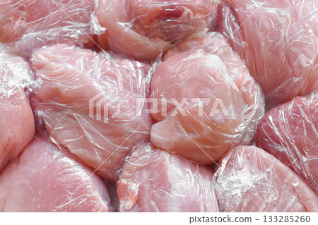 Raw pork in plastic wrap or cling film. Raw pork in plastic wrap or cling film. 133285260