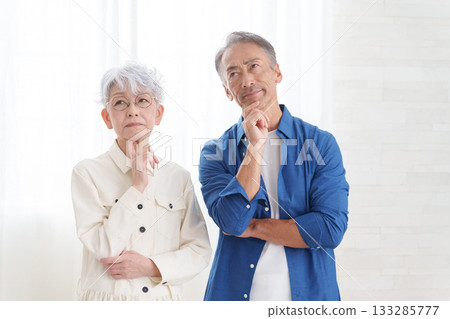 Thinking senior couple in a room 133285777