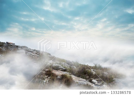Rocky outcrop is rising on misty hilltop, flat design showing boulders, grass, shrubs, cloudy sky 133286578