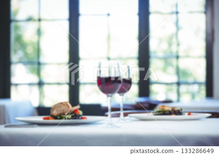 Wineglasses by lamb chop in plate on table Wineglasses by lamb chop in plate on table 133286649