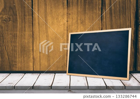 Black board on a wooden table Black board on a wooden table 133286744