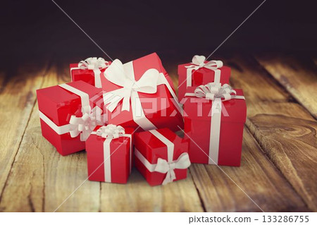 Flat design red gift boxes are resting on rustic plank surface, with white ribbon bows 133286755
