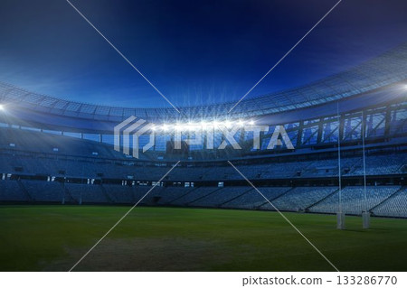 Rugby goalposts are standing in flat design nighttime stadium, with curved seating and floodlights 133286770