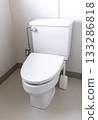 A clean white toilet with the lid closed 133286818