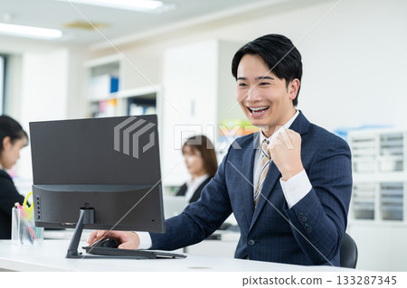 A young businessman working in the office 133287345
