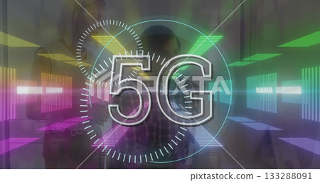 Displaying large 5G graphic overlaying office space, with colleagues holding smartphone and tablet 133288091
