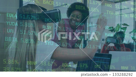 Reaching VR interface, woman in VR headset interacting in office with laptop, glass partition data Reaching VR interface, woman in VR headset interacting in office with laptop, glass partition data 133288292