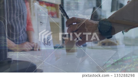 Scanning laptop QR code with hand holding smartphone stylus at office table, documents, coffee cup 133288298