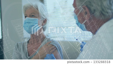 Senior patient receiving vaccine injection in clinic, with syringe gloves masks data overlay blinds 133288318