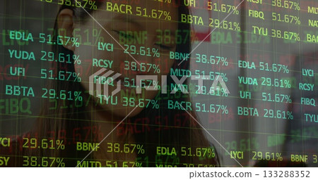 Woman in business attire tracking live stock ticker overlay in modern office, market analysis theme 133288352