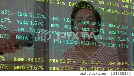 Taking Asian woman's temperature using infrared thermometer in clinic reception, with code overlay Taking Asian woman's temperature using infrared thermometer in clinic reception, with code overlay 133288353
