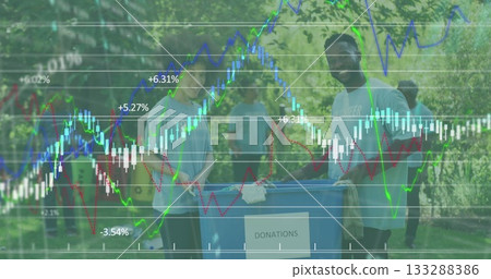 Pushing volunteers in colorful tees and jeans moving donations bin on park walkway, with blue bin Pushing volunteers in colorful tees and jeans moving donations bin on park walkway, with blue bin 133288386