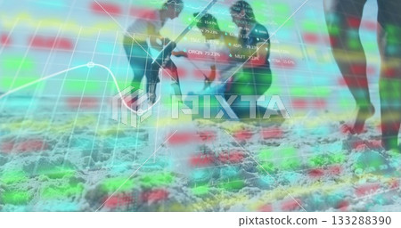 Digging African American woman kneeling on beach at waterline, with shovel and market chart overlay 133288390
