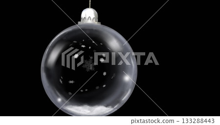 Glass bauble swinging in black studio, with silver cap, string, snowflake motifs and snow layer Glass bauble swinging in black studio, with silver cap, string, snowflake motifs and snow layer 133288443