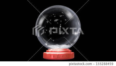 Displaying decorative snow globe with white snowflakes in glass sphere at studio, red star base 133288459