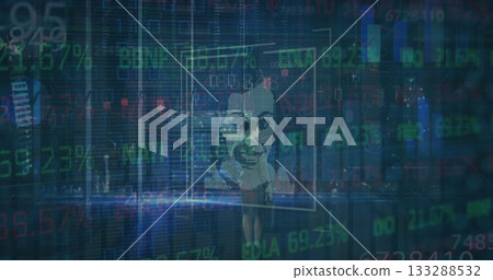 Monitoring businesswoman in suit and heels manipulating holographic data panels in office at night Monitoring businesswoman in suit and heels manipulating holographic data panels in office at night 133288532