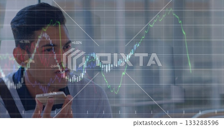 Speaking professional in blazer holding phone at desk with glass divider and charts, copy space Speaking professional in blazer holding phone at desk with glass divider and charts, copy space 133288596