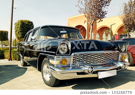 an elegant black vintage sedan at a classic car show on a sunny day 133288779