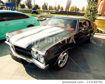 black classic muscle car with white stripes and chrome wheels black classic muscle car with white stripes and chrome wheels 133288780