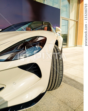 close up of the front of a white sports convertible with an unusual headlight 133288783