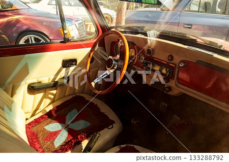 the interior of a classic car with a wooden steering wheel and beige upholstery 133288792
