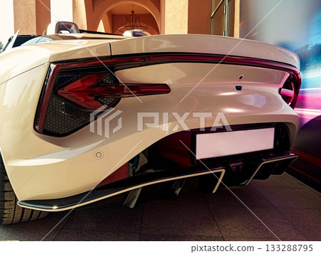 the rear part of a white sports convertible with futuristic taillights and a diffuser the rear part of a white sports convertible with futuristic taillights and a diffuser 133288795