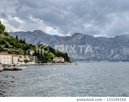 Enjoy the breathtaking coastal view with stunning mountains and a charming village 133289168