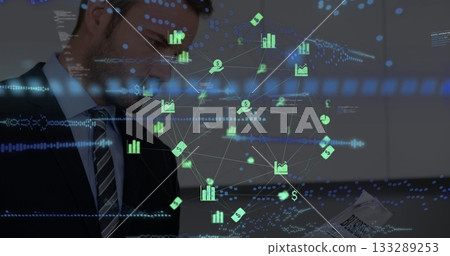 Reading man in suit, tie holding business report in office, with financial data overlay, copy space Reading man in suit, tie holding business report in office, with financial data overlay, copy space 133289253