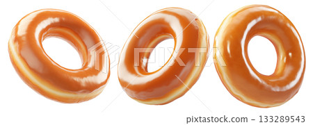 Tasty round donut topped with caramel and vanilla glaze swirl, isolated on white transparent background 133289543