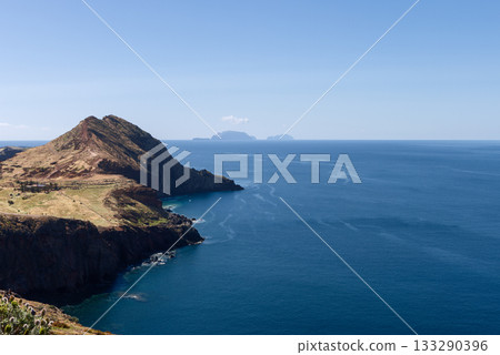 Wide view of Sao Lourenco cliffs and dry slopes with Atlantic stretching to distant islands 133290396