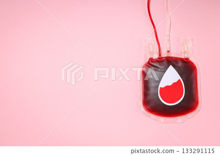Blood donation bag with red liquid against a pink backdrop Blood donation bag with red liquid against a pink backdrop 133291115