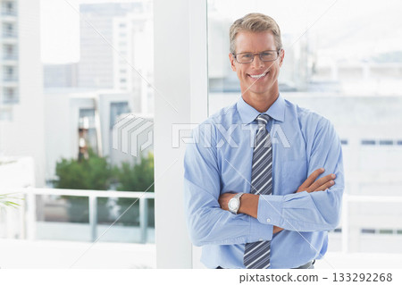 Male executive standing at office lobby, wearing eyeglasses striped tie and wristwatch, copy space 133292268