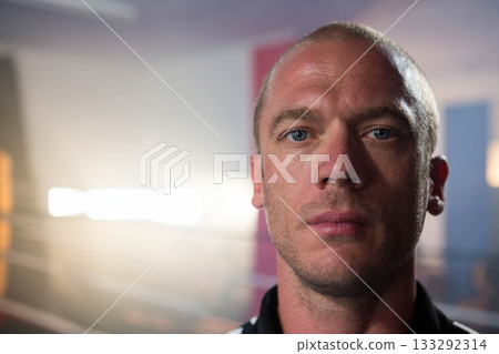 Mature adult man in collared shirt posing in studio with spotlight and colored panels, copy space 133292314