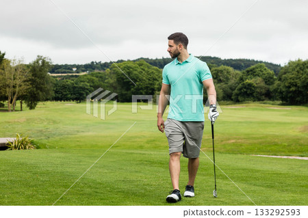 Man wearing golf attire walking across fairway with club, glove and shoes, copy space Man wearing golf attire walking across fairway with club, glove and shoes, copy space 133292593
