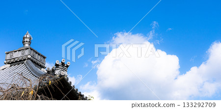A simple landscape of blue sky, clouds and roofs A simple landscape of blue sky, clouds and roofs 133292709