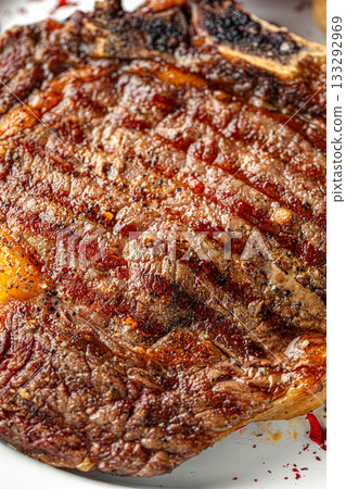 Grilled bone in steak with rich char marks 133292969