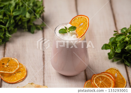 Creamy fruit milkshake with mint garnish Creamy fruit milkshake with mint garnish 133293001