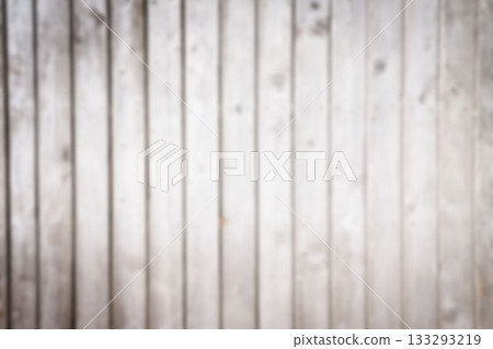 Vertical wooden plank wall is displaying weathered grain in flat design, showing subtle knots 133293219