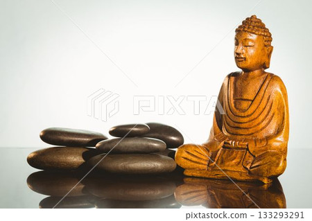 Buddha statue with stacked stones 133293291
