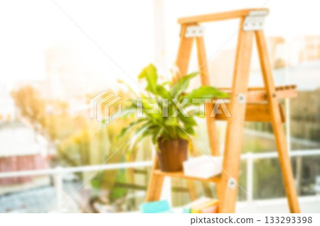 Potted plant on wooden ladder in balcony Potted plant on wooden ladder in balcony 133293398