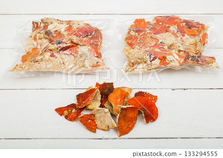 Dried fly agaric in a transparent package on a white background. Dried fly agaric in a transparent package on a white background. 133294555