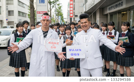A pair of motorcycle gang members holding placards supporting students taking entrance exams on the way to school A pair of motorcycle gang members holding placards supporting students taking entrance exams on the way to school 133294586