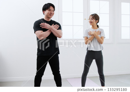 Young woman receiving training from a personal trainer Young woman receiving training from a personal trainer 133295180