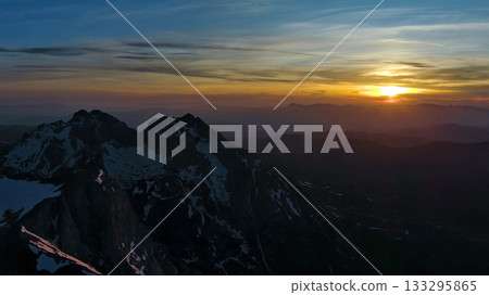 Rocky snow mountains at sunset aerial Rocky snow mountains at sunset aerial 133295865