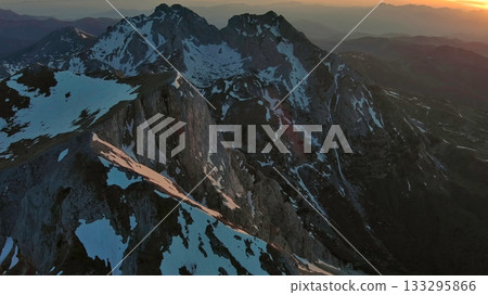 Rocky snow mountains at sunset aerial Rocky snow mountains at sunset aerial 133295866