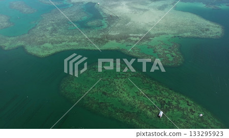 Coral reef and fish farm with cages for fish Coral reef and fish farm with cages for fish 133295923