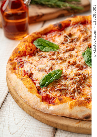 Fresh baked pizza with cheese and basil Fresh baked pizza with cheese and basil 133296003