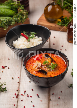 Spicy tom yam soup with rice served together Spicy tom yam soup with rice served together 133296034