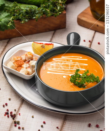 Creamy pumpkin soup with croutons garnish 133296037