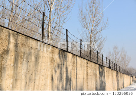 Concrete outer wall and barbed wire fence surrounding Unit 731 in Harbin 133296056